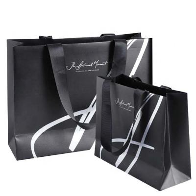 China Handmade Custom Gift Bag Shining Logo Clothes Branded Shopping Paper Bags With Rope Handles for sale