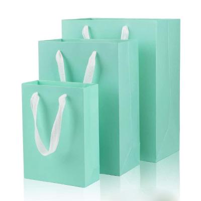 China Recyclable Wholesale Customized Fashion Promotional Cosmetics Packaging Blue Paper Bag Color Printing Paper Bags With Ribbon Handles for sale