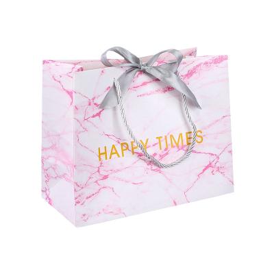 China Paper bag with bow tie ribbon logo custom pink marble shopping bag with bow ribbon wedding gift paper bags for guest for sale