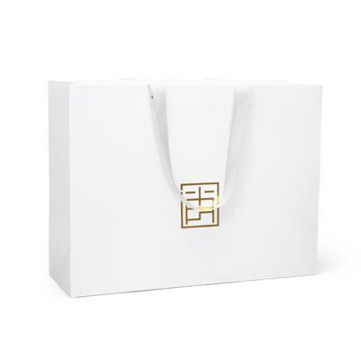 China Custom Recycled Materials Luxury Brand Logo Apparel Paper Bag For Garment Boutique Gift Packaging Shopping Bags With Ribbon Handles for sale