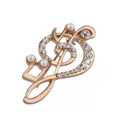 China Global Hot Selling Crystal Brooches Coat Decoration Fashion Note Brooch Luxury Pin For Women Lady for sale