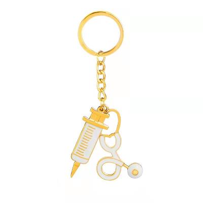 China Key Chains Medical Key Chains Syringe Global Stethoscope Metal Gold Nursing Keychains for Doctors Nurse Jewelry Gift for sale