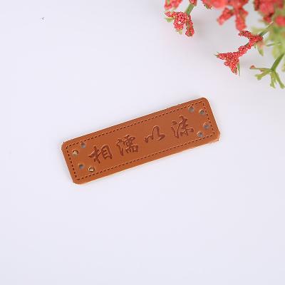 China Sustainable Fashion New styles Embossed coffee leather PU patches label for jeans for sale