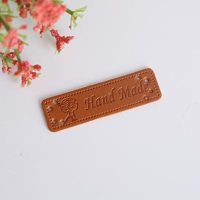 China Sustainable Wholesale High Quality Garment Pu Leather Labels Hand Made Tags For Clothes for sale