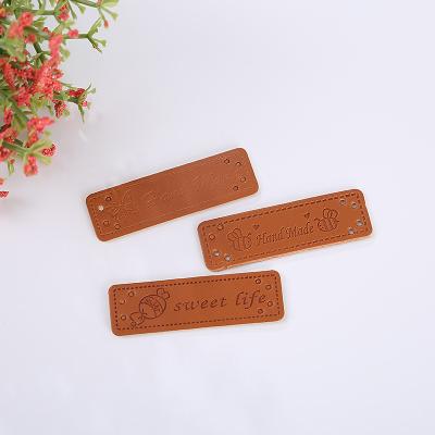 China Sustainable Custom Brand Logo Garment Pu Leather Label Embossed Label Printed Tag Clothing Accessories For Clothes Jeans Bags Shoes Caps for sale