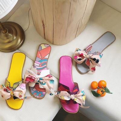 China Ladies Plastic Bowknot Slides Casual Outdoor Beach Soft Unique Flat Sandals Ladies Slippers for sale