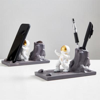 China China's New Creative Cute Astronaut Pen Holder Multi-Function Mobile Phone Frame Home Decor Resin Crafts for sale