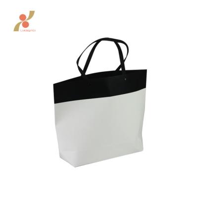 China Recyclable Recycled Custom Folded Handle Black White Kraft Paper Bag for sale