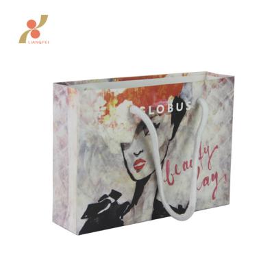 China Recyclable Custom Printing Popular Gift Art Paper Bags With Logo for sale