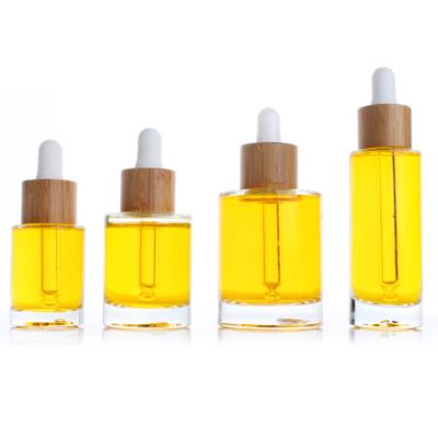 China Personal Care 15ml 30ml 50ml Bamboo Cap Glass Bottle Cosmetic Essential Oil Bottles for sale