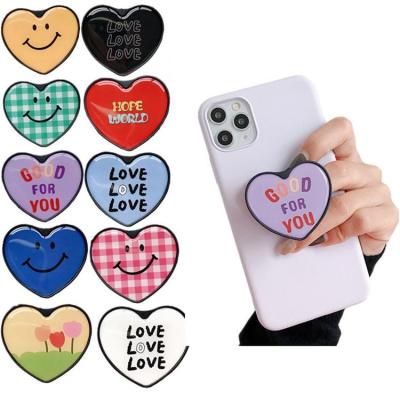 China Popular New Cute Phone Shaped Epoxy Resin Phone Grip HolderHeart Plug Adjustable With Logo for sale