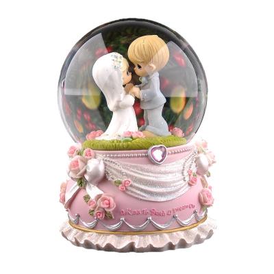 China Crystal Ball Merge With Music Box Gift For Girlfriend Or Wife LED Color Resin Wedding Sculpture Wedding Theme Water Snow Globe Music Box for sale