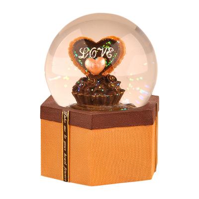 China Wholesale Custom Made Europe High Quality Resin Wedding Souvenirs Snow Globe Chocolate Music Box For Gift for sale