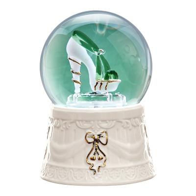 China Crystal Ball Merge With Music Box Gift For Girlfriend Or Wife Occupation Home Decorative Carving Ornaments Shoes Snow Globe Desktop Music Box for sale