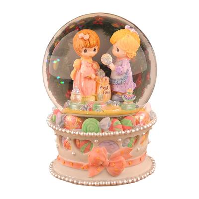 China Europe High Quality Souvenirs Wholesale Custom Creative Resin Opens Candy Girl Snow Globe Music Box For Gift for sale