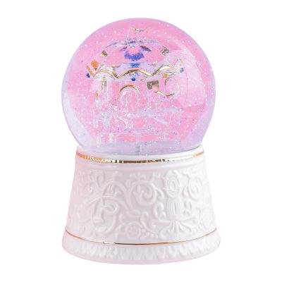 China Carving Glass Desktop Ornaments Swept Glass Process Carousel Snow Globe Built-in Music Box for sale