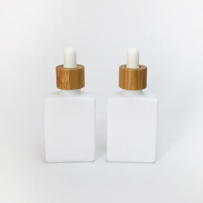 China 30ml Cosmetic White Matte Frosted Glass Dropper Essential Oil Bottle With Bamboo Cap 30ml 1Oz for sale