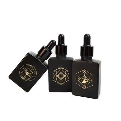 China Cosmetic Serum 30ml High Quality Black Frosted Rectangle Shape Glass Dropper Bottle With Logo Stamping for sale