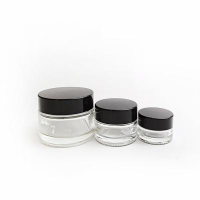 China Fashional cosmetic design 30ml/50ml/100ml frosted glass bottle clear cream jar cosmetic packaging jars with black lid for sale