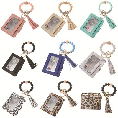 China Environmental Friendly Keychain Bracelet Key Chain Silicone Tassel Card Leather Wallet Beaded Wrist Chain Bracelet Key Holder for sale