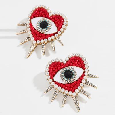 China Red Bohemian Stud Earrings BOHEMIA African Heart Seed Beaded Evil Eye Earrings For Women for sale