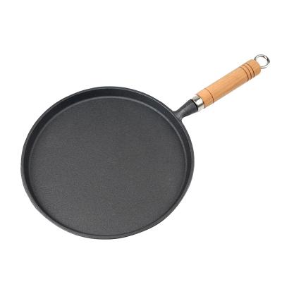 China Best Operation Easy Selling Cast Iron Handle Flat Bottom Wood Frying Pan For Household Cooking Nonstick Cookware for sale