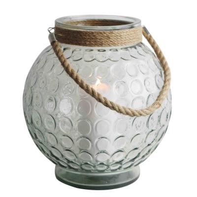 China Hot Selling Home Decoration Rope Handle Ball Shape Outdoor Hurricane Glass Lantern for sale