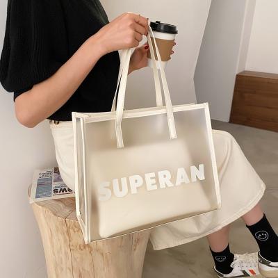 China Large-capacity female all-match fashion new fashion Insti letter fresh transparent hand carrying single shoulder bag jelly packaging bag for sale