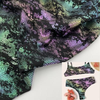 China Wicking the latest printed colorful rainbow to foil instant 4 way knitted elastic nylon swimsuit fabric for sale