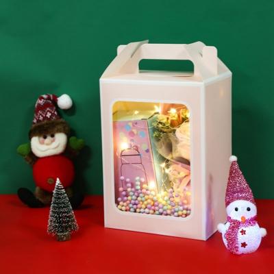 China Custom Folding Paper Box With Handle And Clear Window Front L*W*H cm For Candle Packaging for sale