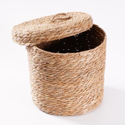 China Amazon Sustainable Hot Selling Round Storage Basket With Lid Straw Desktop Sundries Cabinet Basket for sale