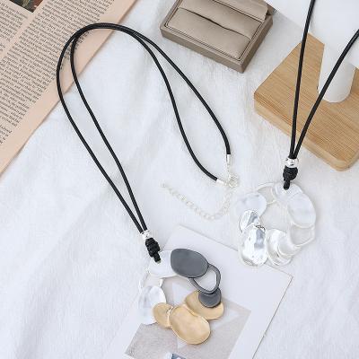 China Add UV-coating on Surfuce product to prevent tarnishing along irregular geometry alloy sweater pendant black leather necklace for girls gifts for sale