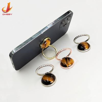 China Adjustable Crystalize Gemstone Quartz Tiger Eye Zinc Alloy Universal Custom Card Fingir Cell Phone Holder Ring for sale