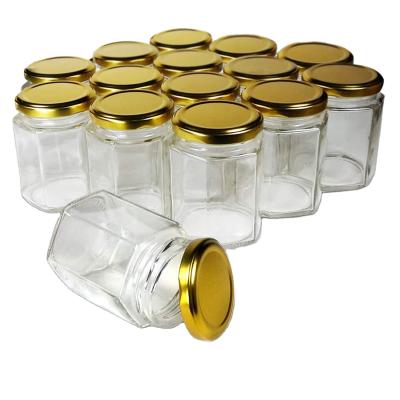 China Freshness Preservation Factory Selling Clear Hexagonal Glass Jar Honey Candle Glass Jar With Metal Lids for sale