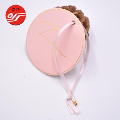 China Sustainable Gold Hot Foil Printing Embossed Name Swing Hang Tag With Pink Ribbon for sale