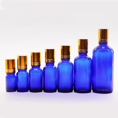 China Essential Oil Cosmetic Blue Glass Cosmetic Dropper Bottle For Hair Oil Roll On Cap for sale