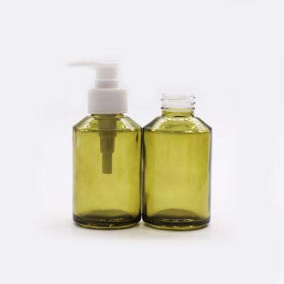 China 120ml Empty Green Glass Cosmetic Pump Shampoo Conditioner Pump Bottles for sale