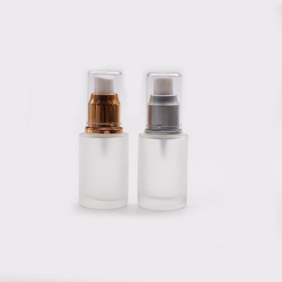 China 30ml Flat Shoulder Pump Cosmetic Amber Frosted Glass Bottle With Lotion Pump for sale