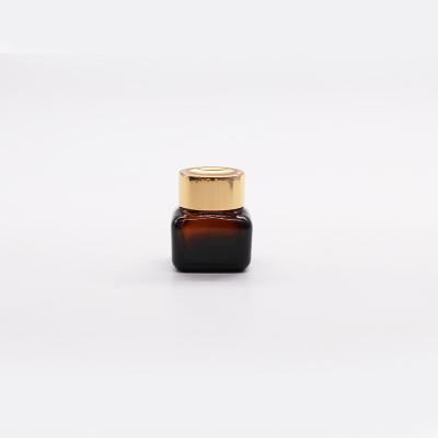 China Luxury Cosmetic Amber Glass Jars For Eye Face Creams Jar With Gold Cap Lids for sale