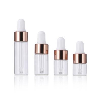 China 1ml 2ml 3ml 5ml Empty Cosmetic Essential Oil Serum Clear Glass Dropper Bottle With Colorful Top for sale