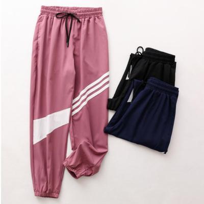 China Anti-Wrinkle 2022 Summer Quick-Dry Running Pants Light Up Breathable Casual Loose Harem Pants Plus Size Sports Pants for sale