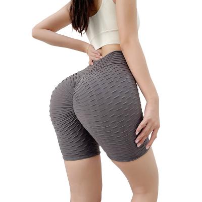 China Elastic yoga hip peach jacquard buttocks sports tights hip lift fitness pants breathable seamless five-point waist high handsome pants for sale