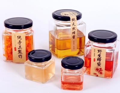 China Food Grade 180ml Hexagon Honey Bottle Glass Honey Bottle With Flip Lid for sale