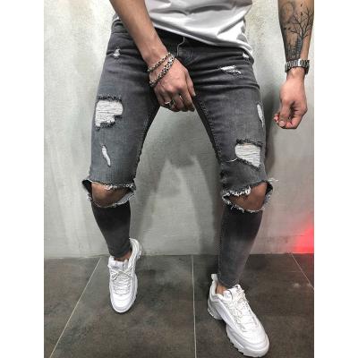 China Trend Breathable Mid Waist Fashion Skinny Pencil Pants Tapered Ripped Hollow Out Knee Hole Jeans Pants For Men for sale