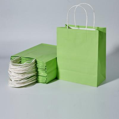 China Disposable Logo Color Packaging Bags For Custom Gift Garment Handle Green Kraft Paper Craft Wrapping Paper Bag for sale