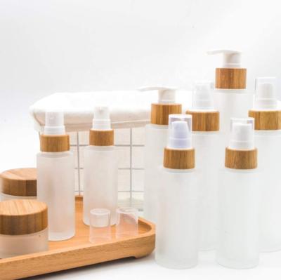 China Stock Frosted Empty Essential Oil Perfume 50ml Glass Bottles With Wooden Screw Cap for sale