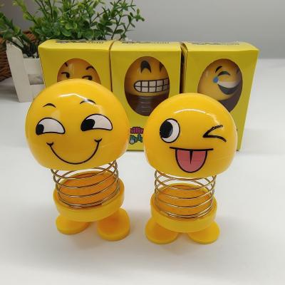 China Spring Smiley Doll Little Globe Face Yellow Vibrato Shaking New Main Doll Car Ornament Doll Peculiar Toy for sale