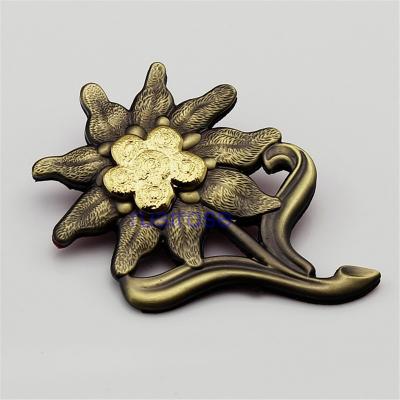 China Customized three-dimensional flower metal OEM, high-end furniture brand badges, edelweiss antique badge for sale