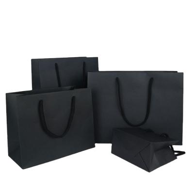 China Recycled materials black simple black paper shopping bag custom luxury hot packing gift bags shopping bag for apparel gift for sale