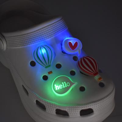 China Wholesale Hot Selling 2022 LED Shoe Charm LED Light Up Cool Sparkle Shoe Charms For Kids PVC Sandal Clogs Croc Charm for sale